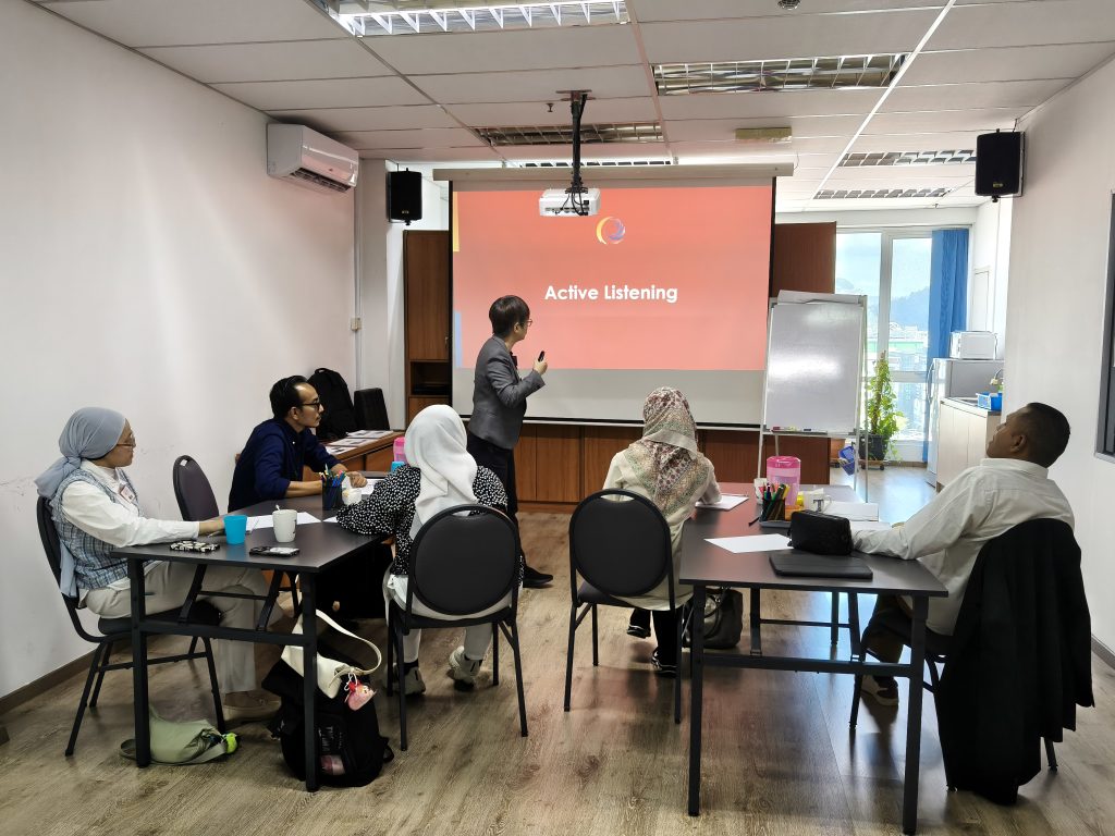 Coach presenting on active listening to the participants which most are leaders and managers from different industries